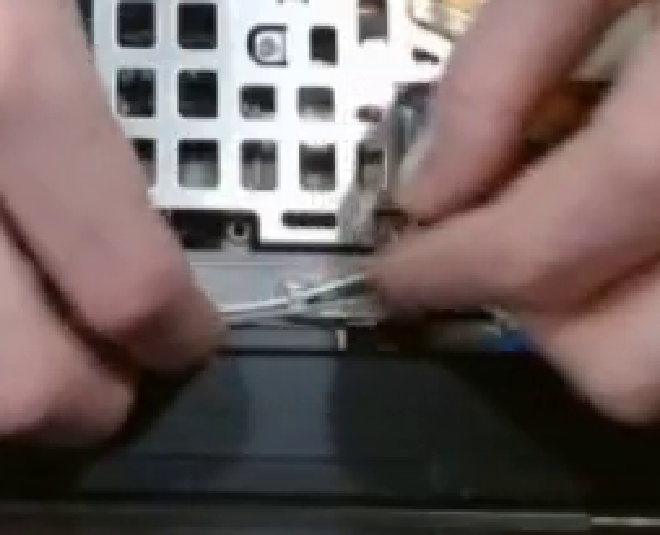 Pushing Antennae Into a Clip Over the video cable